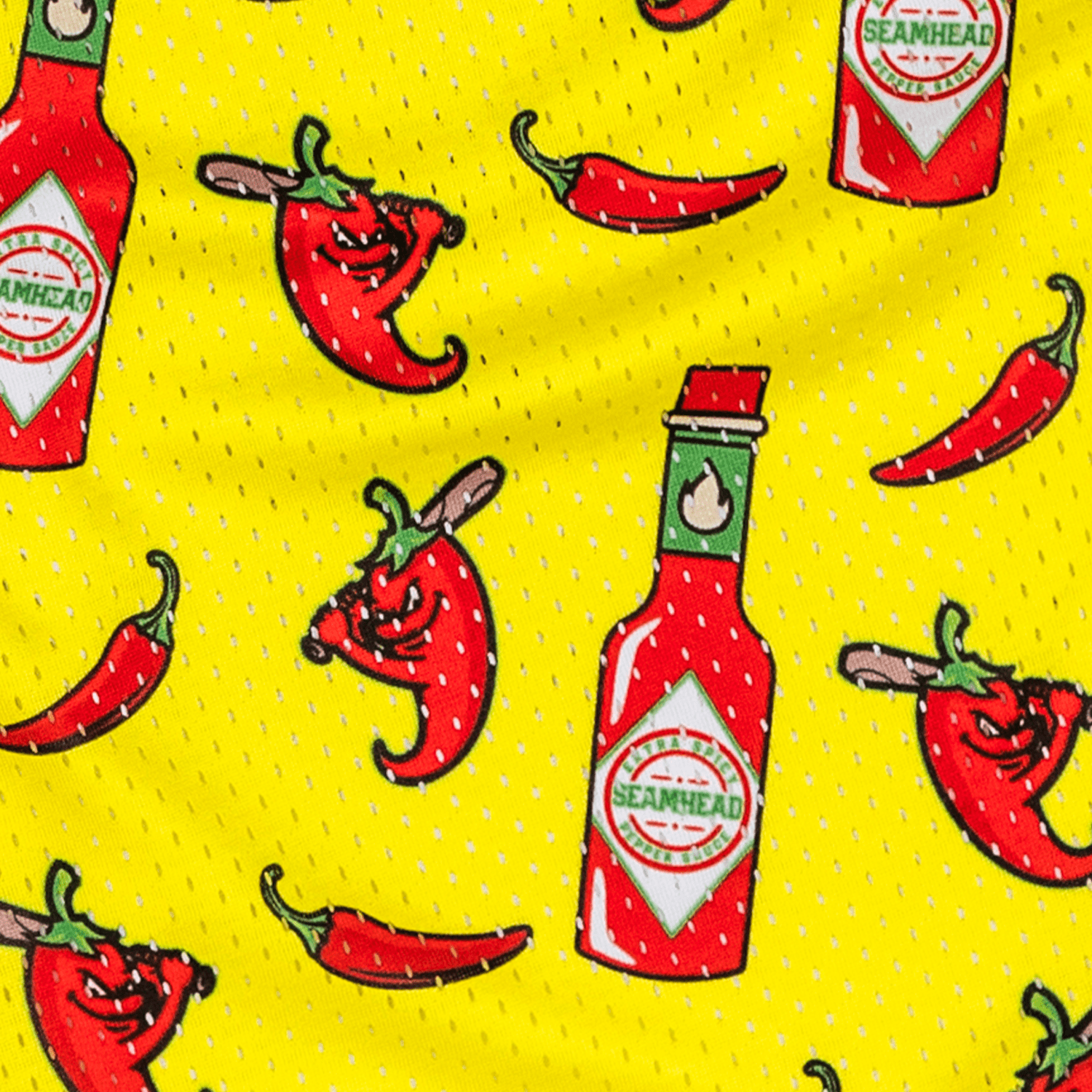 Pattern of red hot sauce bottles and red peppers on a yellow athletic youth shorts