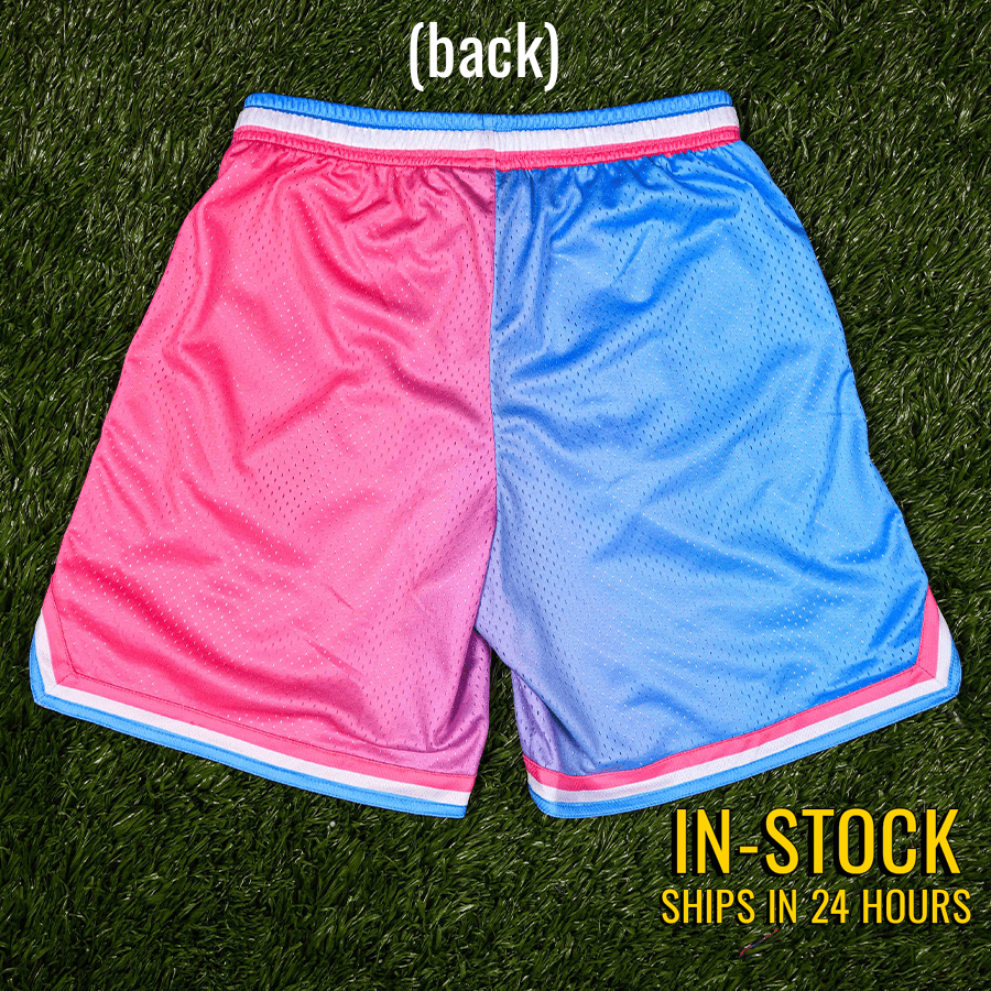 Collection of Pink and blue shorts on a grass background with text indicating stock availability. in a gallery layout
