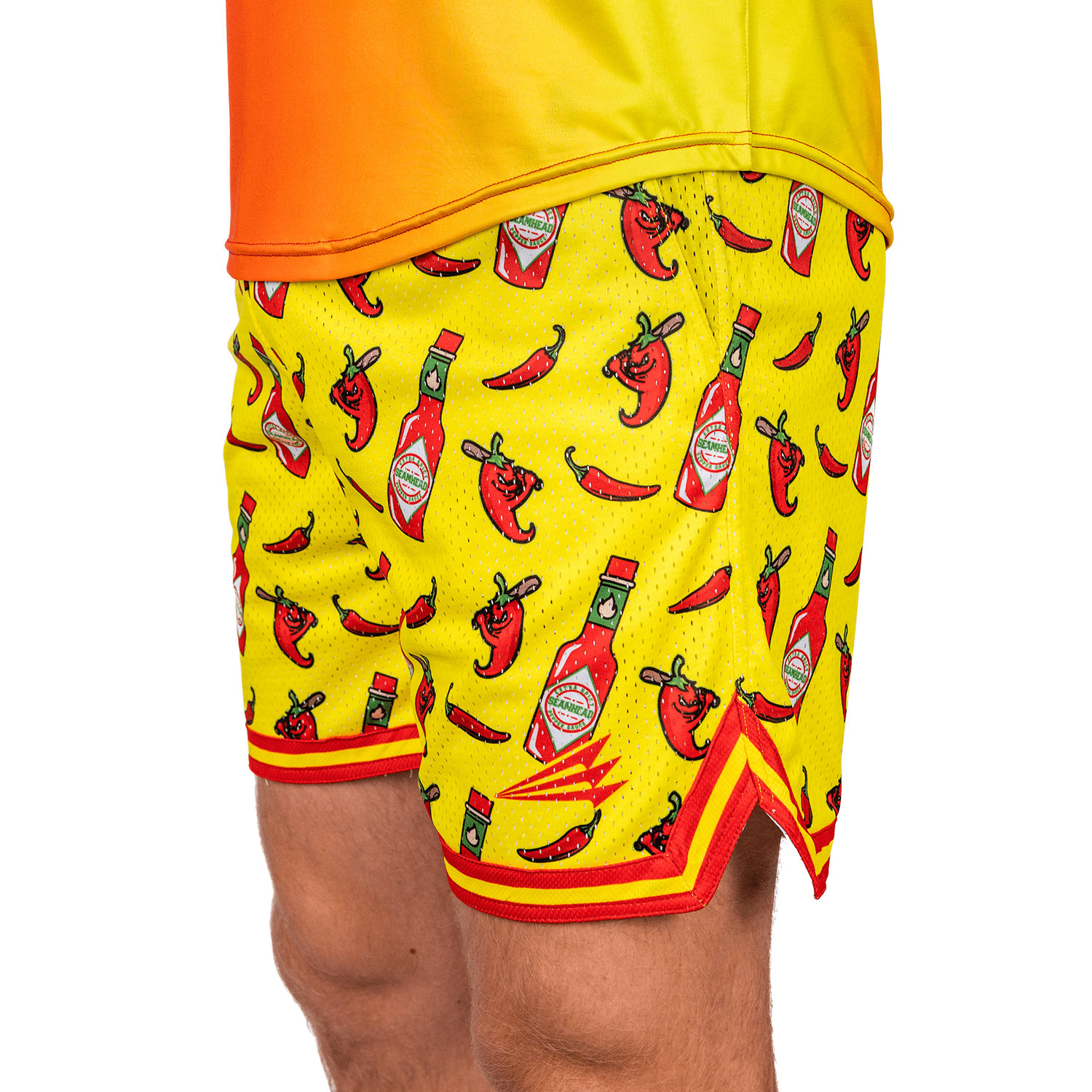 Collection of Yellow athletic shorts with hot sauce and chili pepper pattern on a white background in a gallery layout