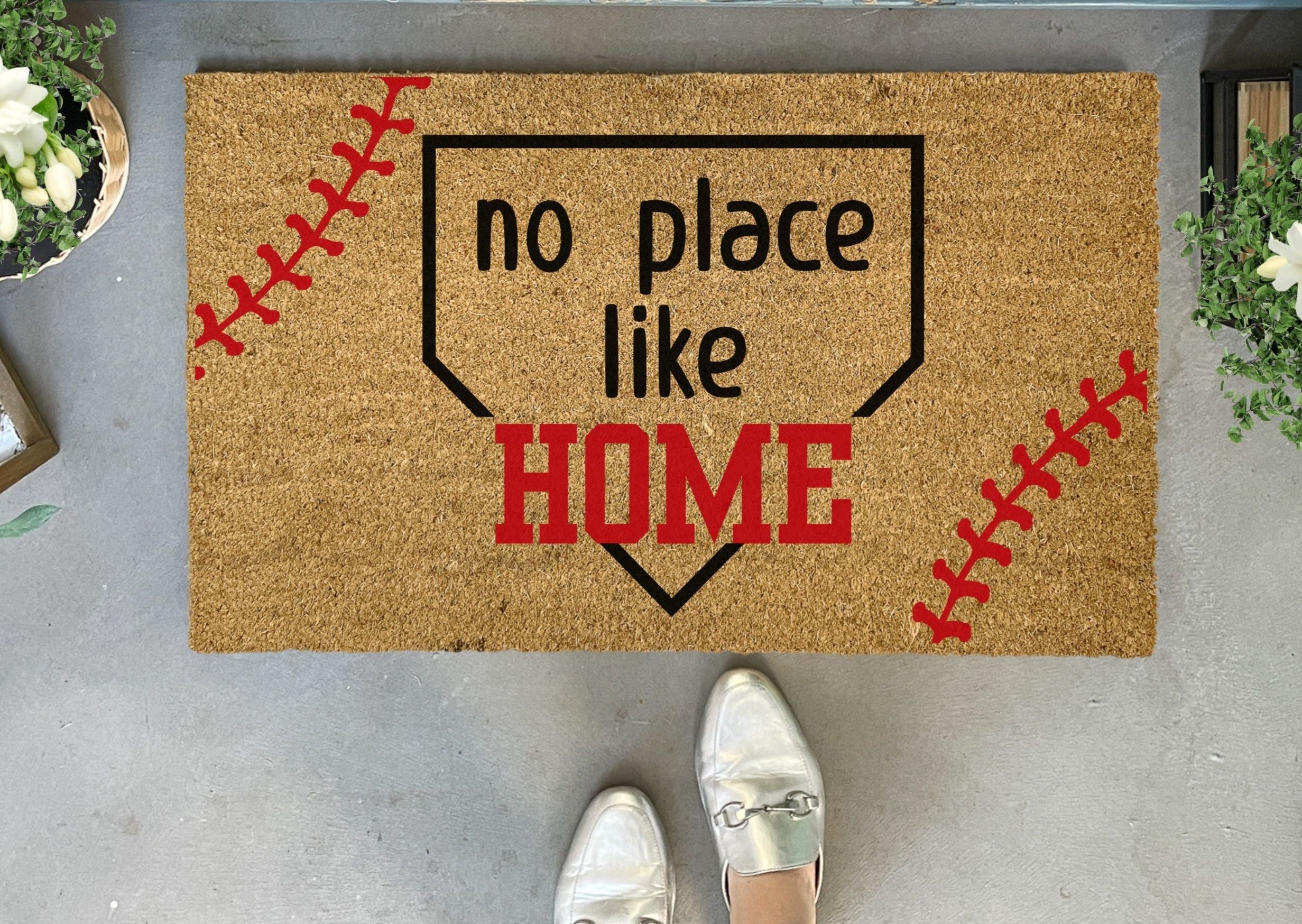 Collection of Doormat with 'no place like HOME' text and baseball design on a concrete floor. in a gallery layout