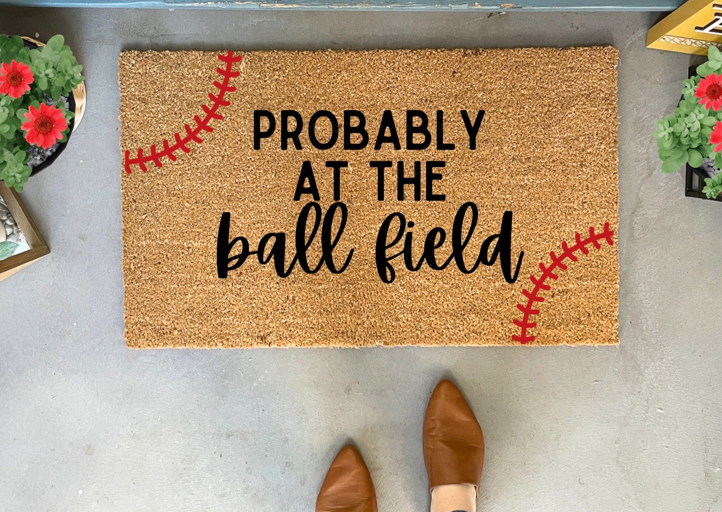 Collection of Doormat with 'Probably at the ball field' text and baseball design on a concrete floor. in a gallery layout