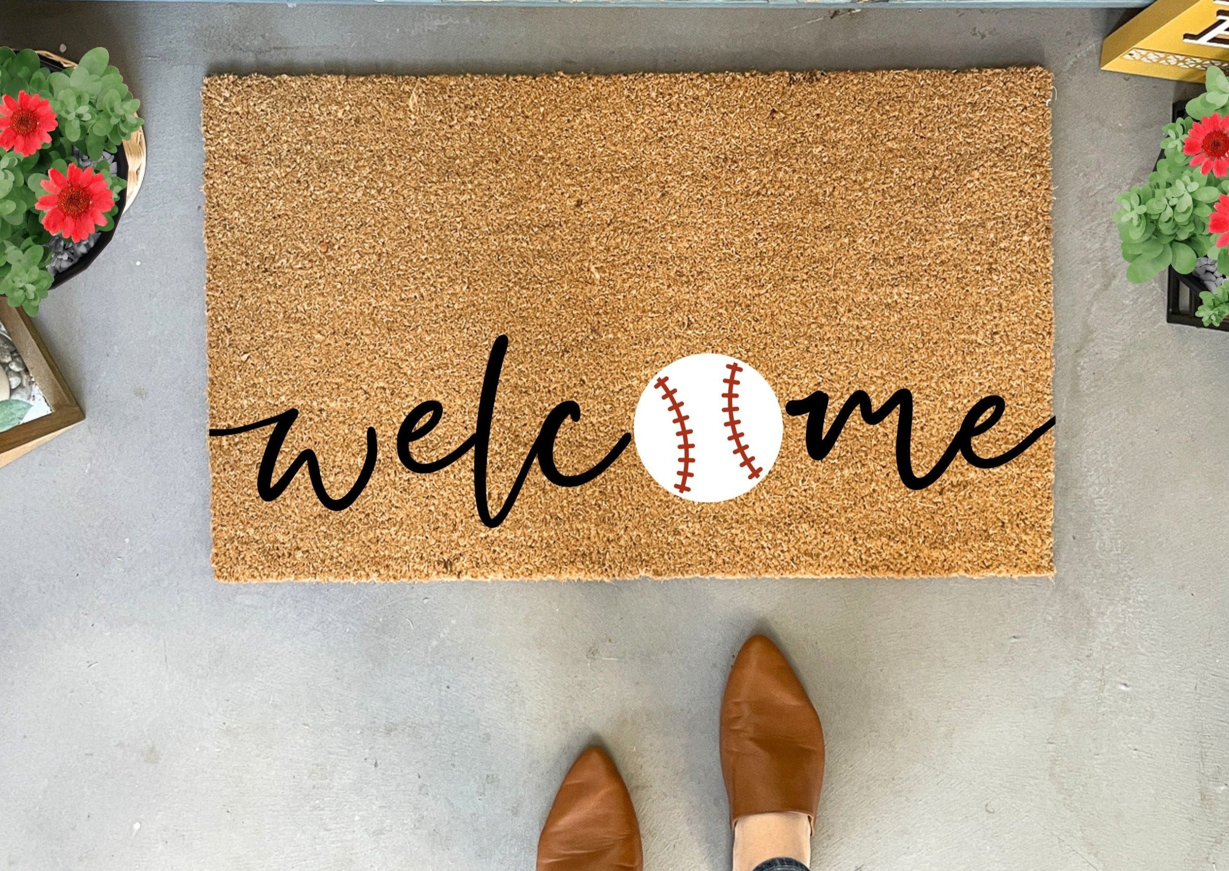 Collection of Doormat with 'welcome' and baseball design on a concrete floor. in a gallery layout