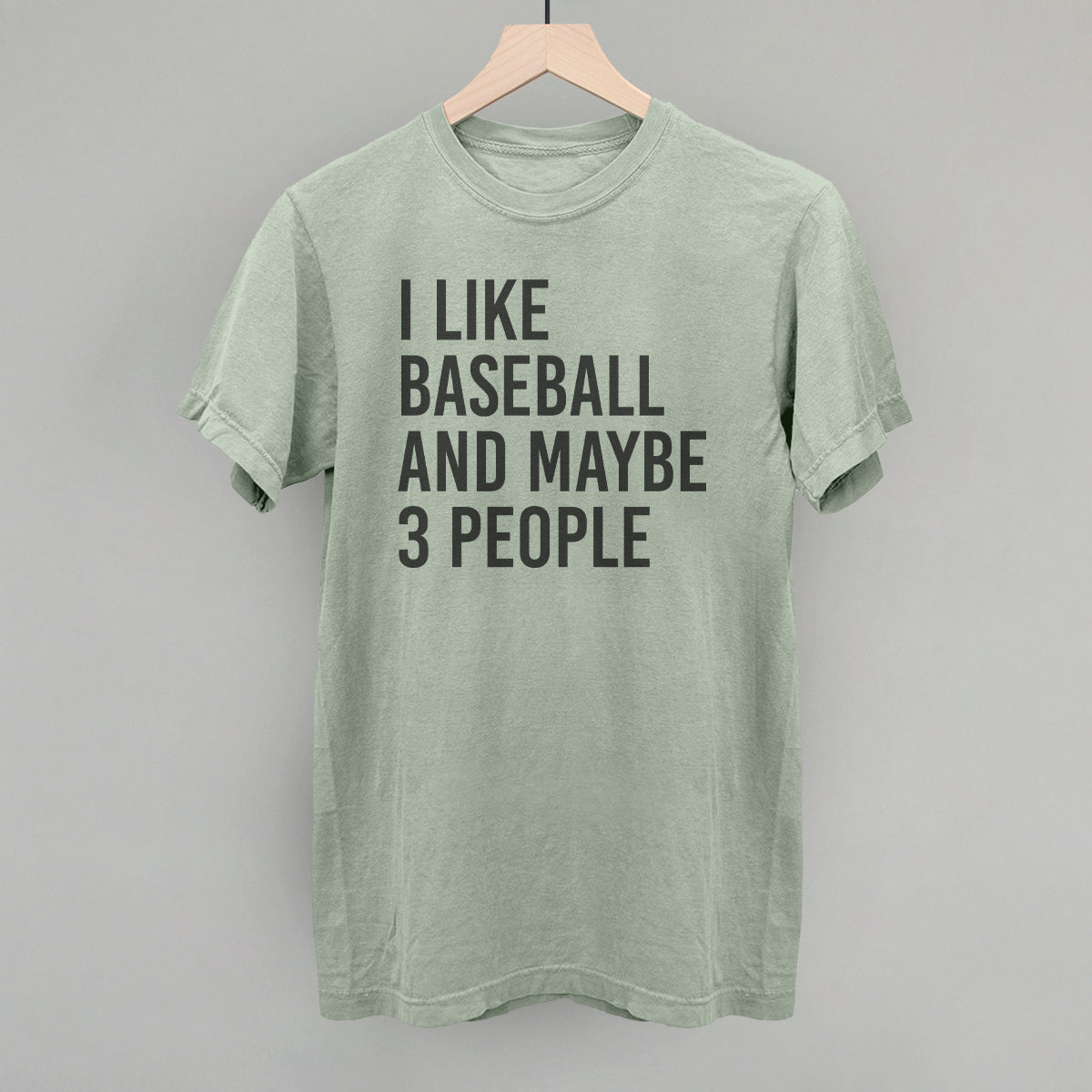 Collection of Green t-shirt with text 'I like baseball and maybe 3 people' on a gray background in a gallery layout