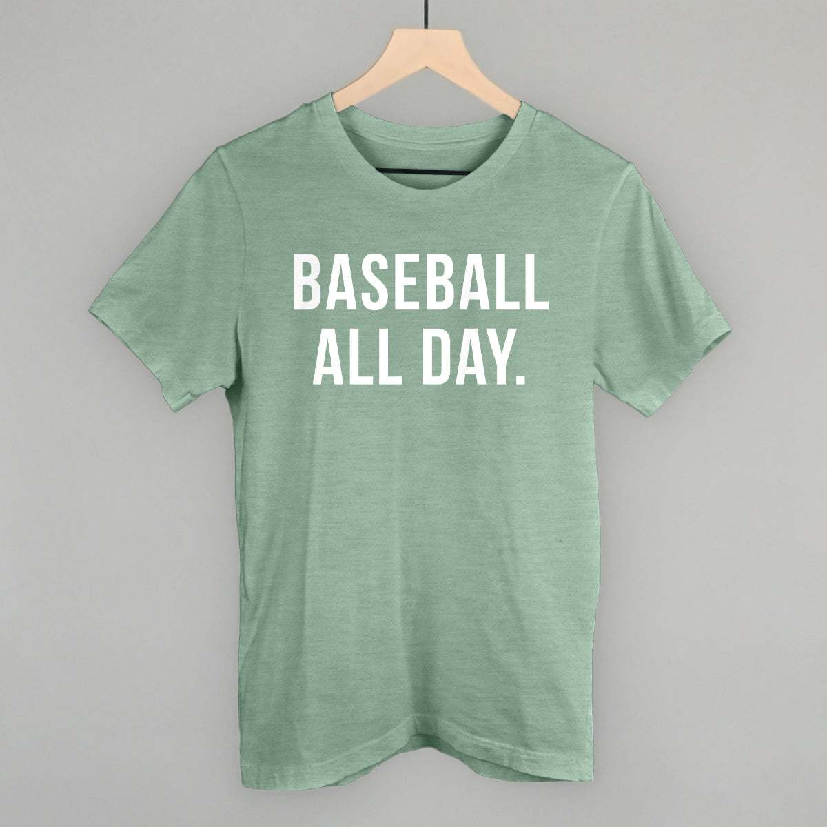 Collection of Green t-shirt with 'BASEBALL ALL DAY.' text on a hanger against a gray background in a gallery layout