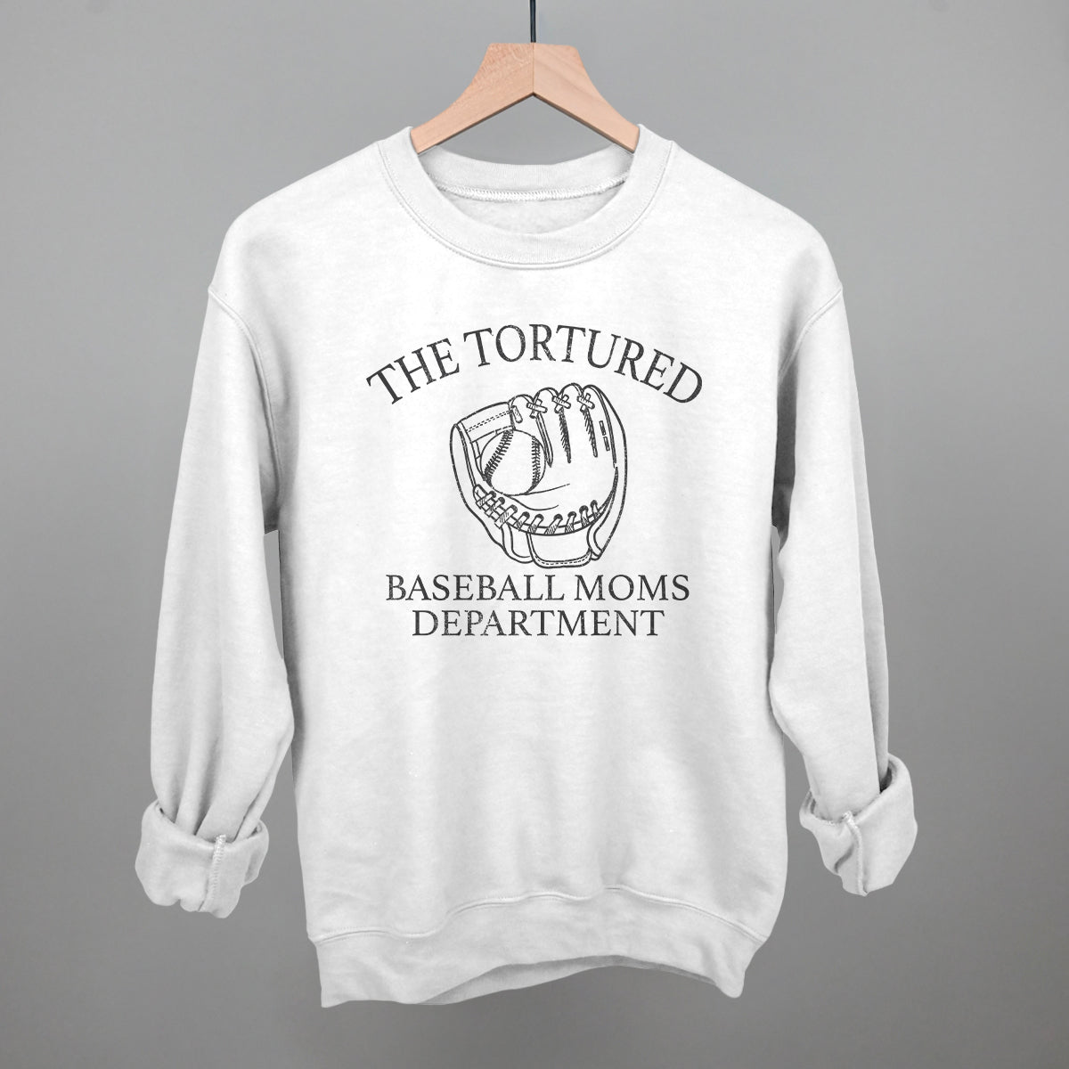 White sweatshirt with 'The Tortured Baseball Moms Department' text and graphic on a gray background