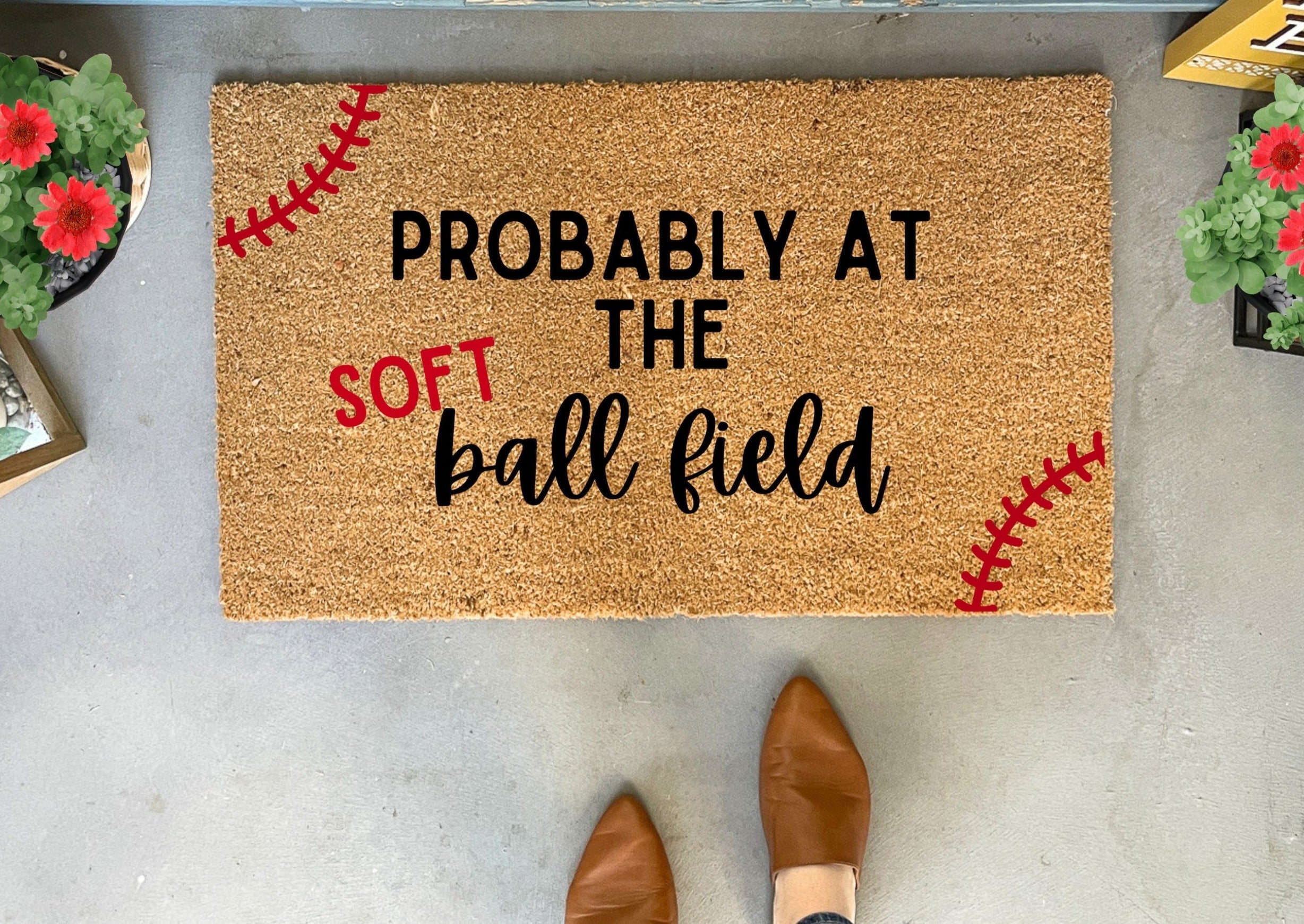 Collection of Doormat with text 'Probably at the softball field' on a concrete floor. in a gallery layout