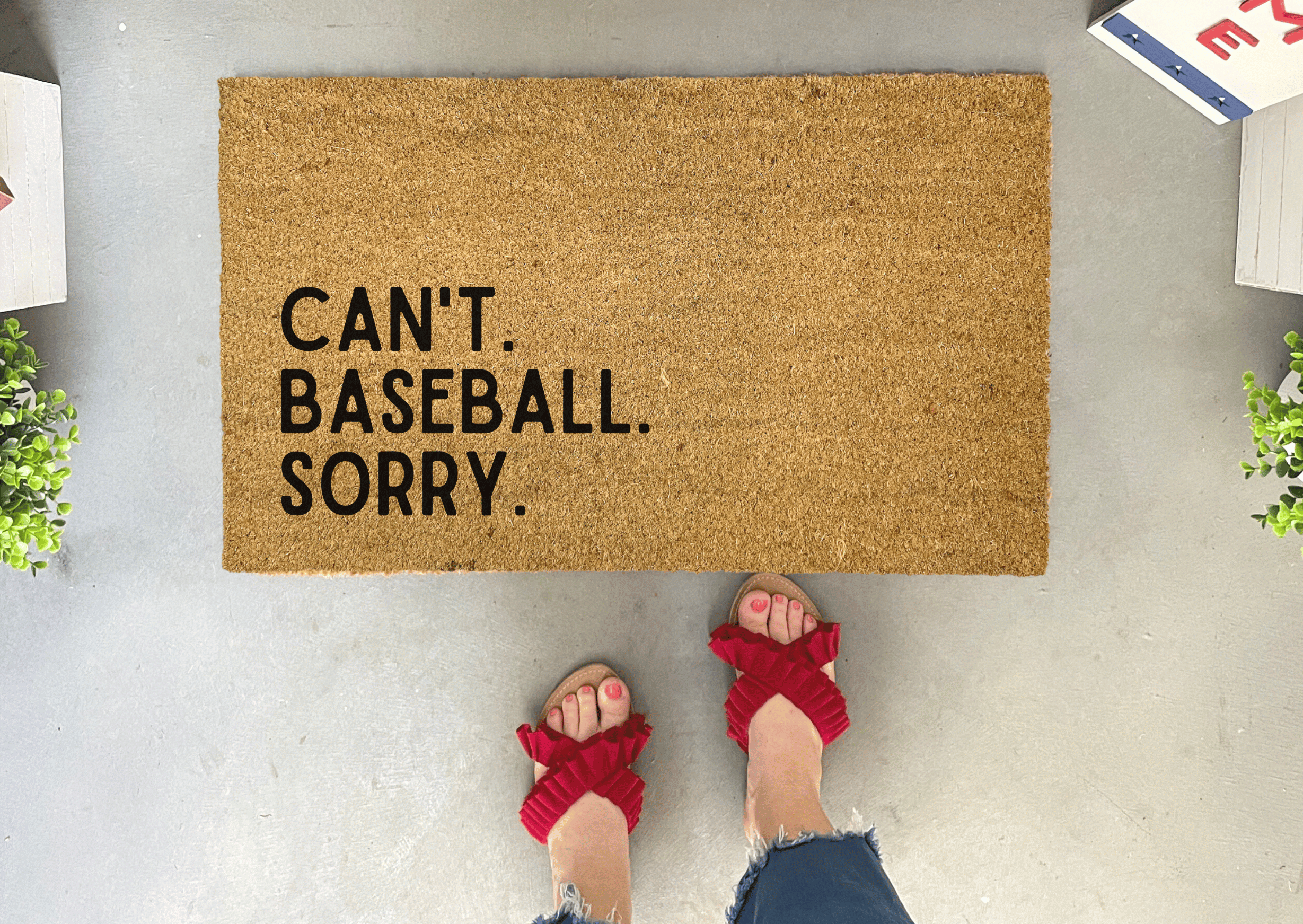 Collection of Doormat with 'Can't. Baseball. Sorry.' text on a gray floor with red sandals. in a gallery layout