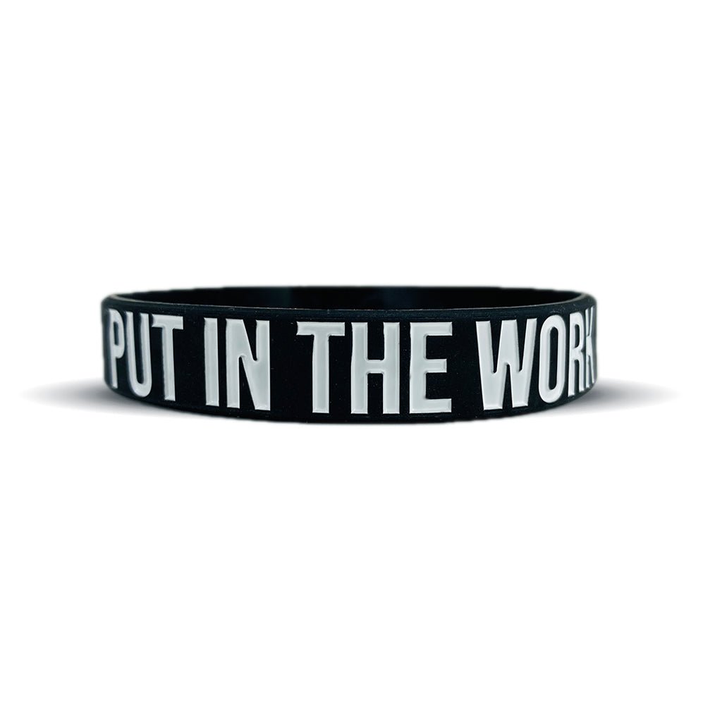 Collection of Black wristband with 'PUT IN THE WORK' text on a white background in a gallery layout