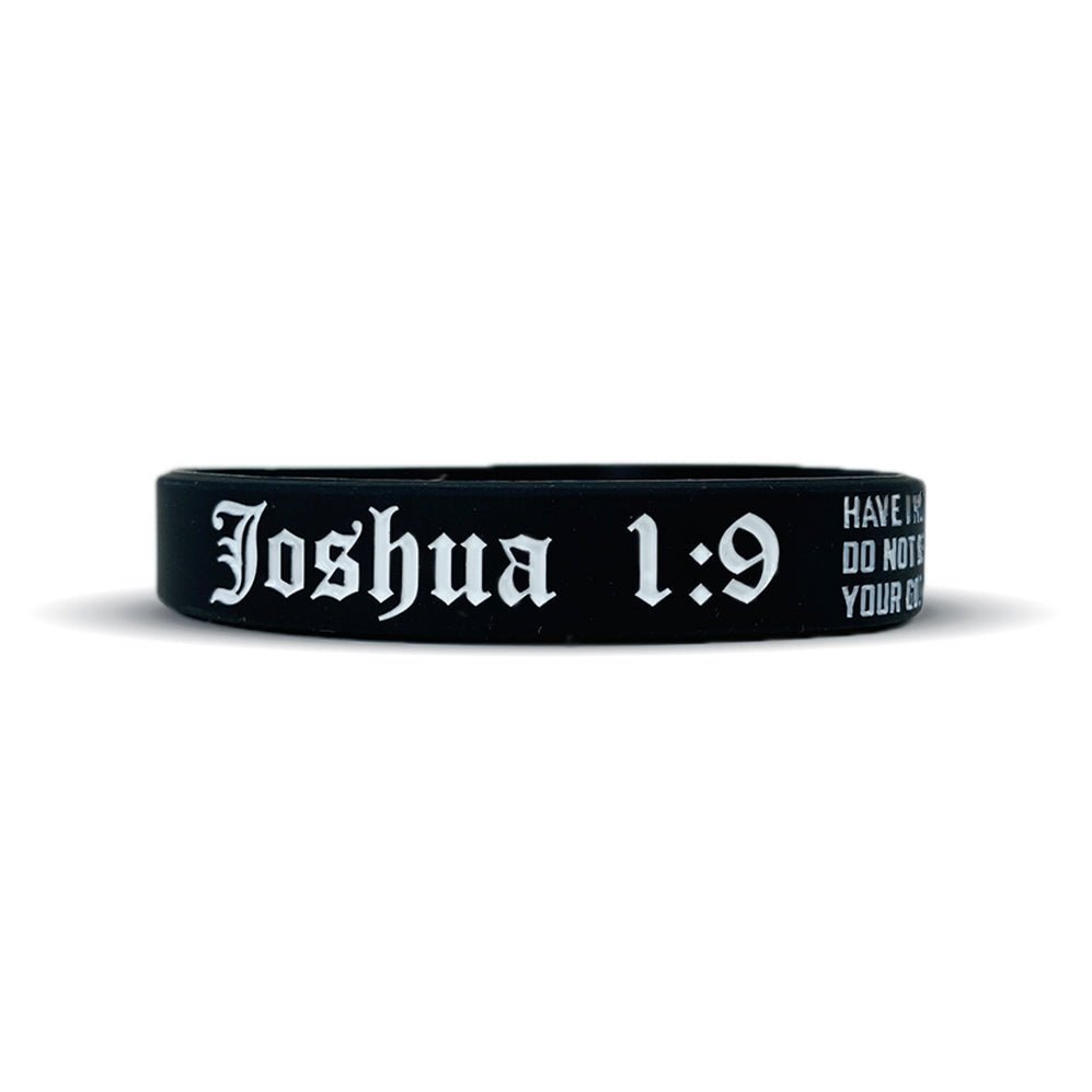 Black wristband with 'Joshua 1:9' text on a white background