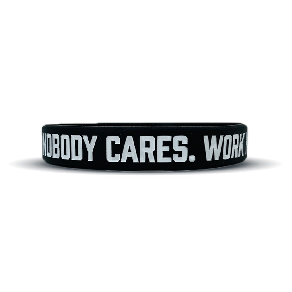 Collection of Black wristband with white text 'NOBODY CARES. WORK' on a white background in a gallery layout