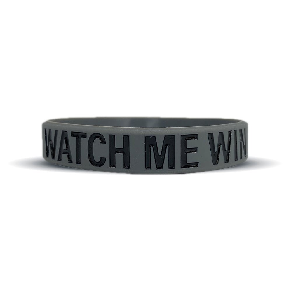 Collection of Black wristband with 'WATCH ME WIN' text on a white background in a gallery layout