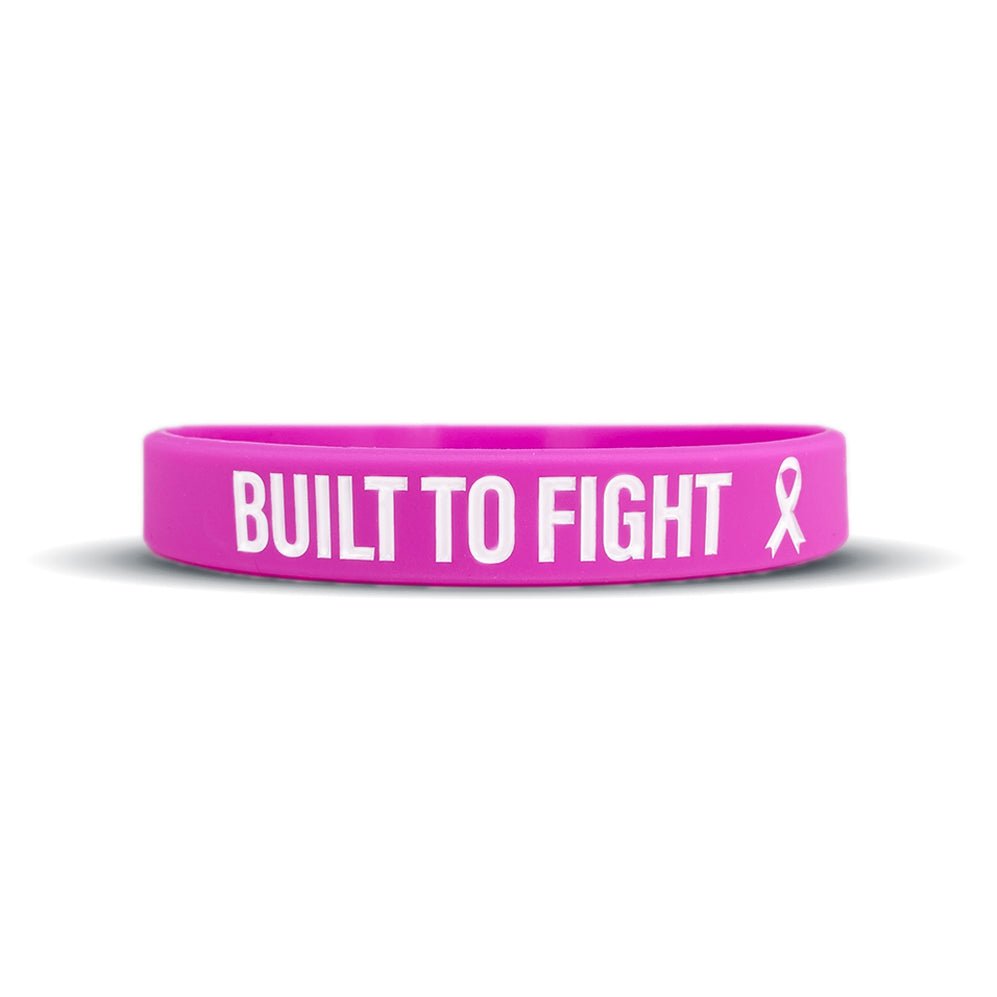 Pink wristband with 'BUILT TO FIGHT' text and a pink ribbon on a white background