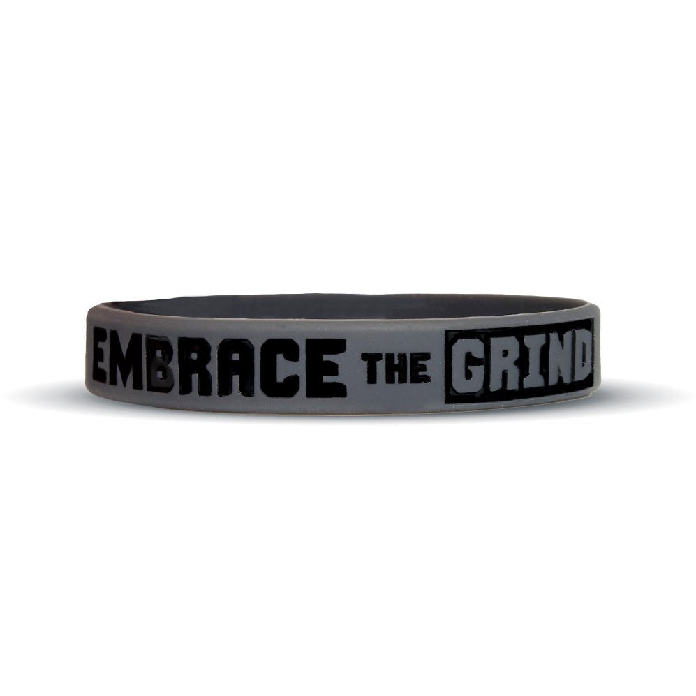 Gray wristband with 'Embrace the Grind' text on a white background